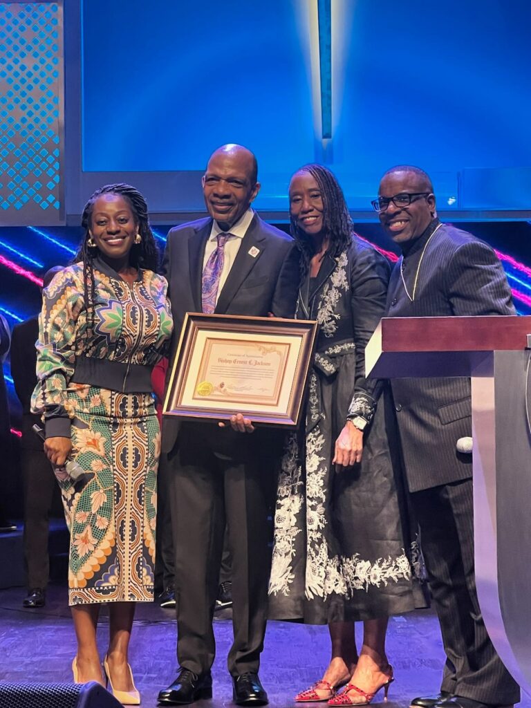 Bishop Ernest L. Jackson receiving a Certificate of Appreciation for 28 years of service, surrounded by friends and church leaders